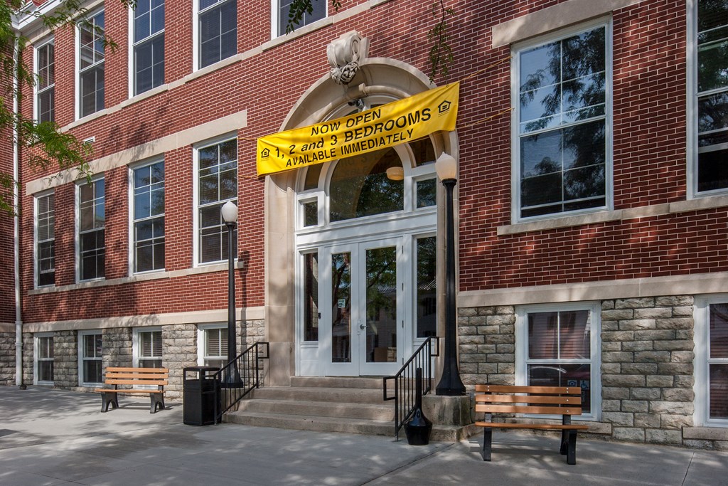 a brick building with a yellow sign in front