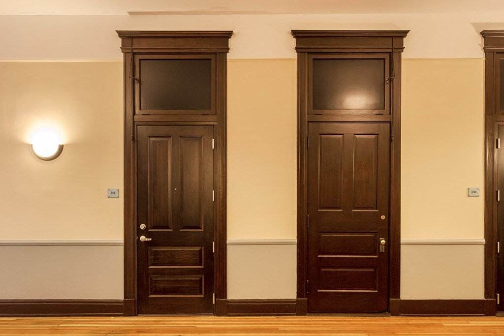 a set of three wooden doors in a room