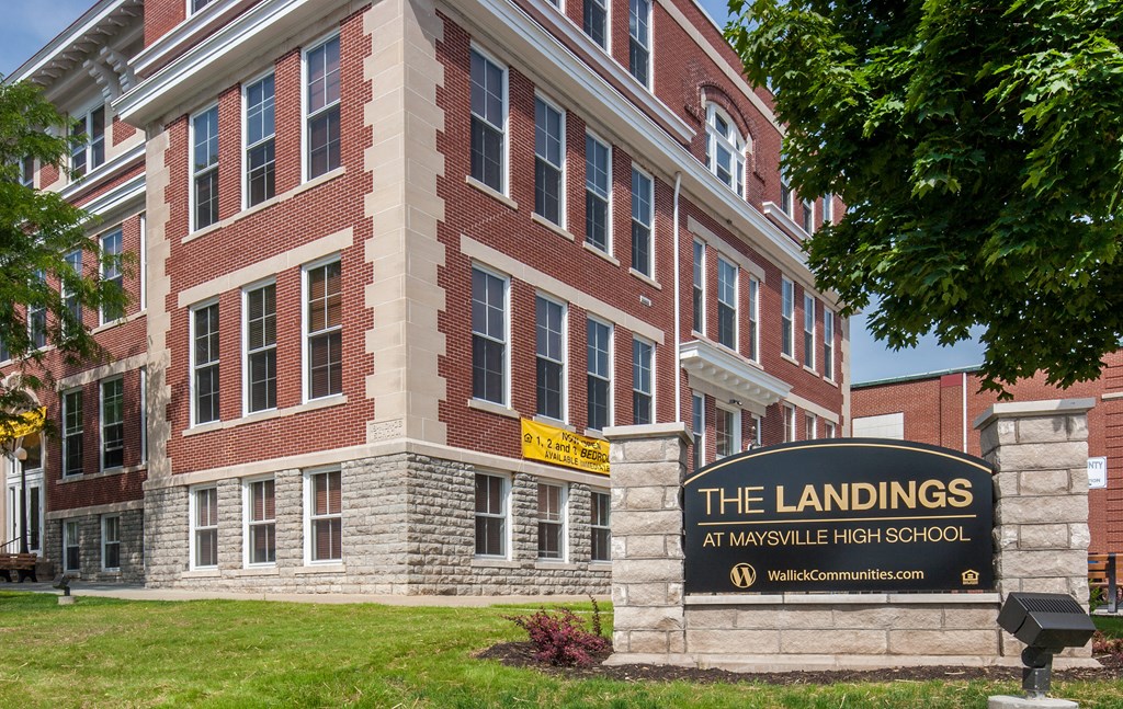 a brick building with a sign for the landings
