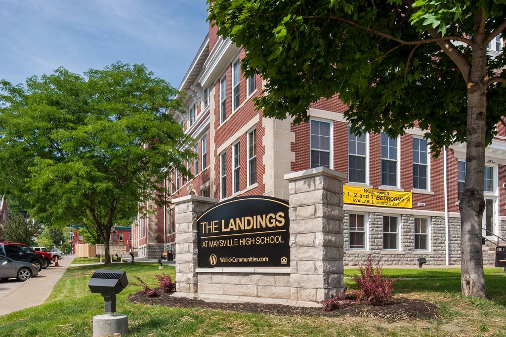 a large brick building with a sign for the landings on the front of it