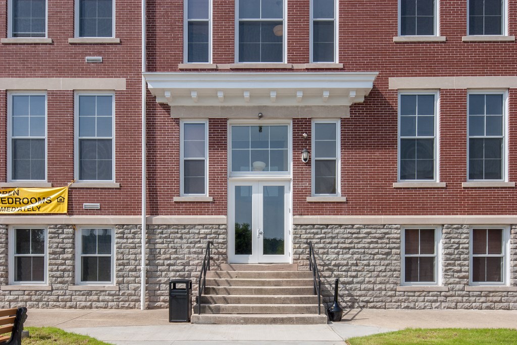 the front of a brick building with a white door