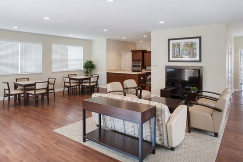 a living room with a couch and chairs and a table