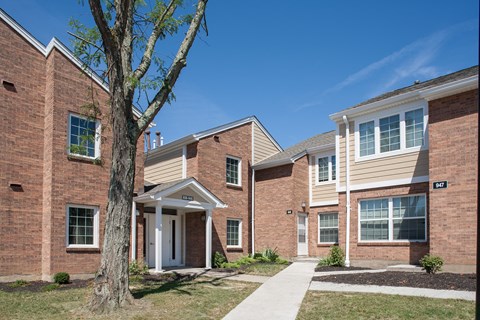 a brick building with a tree in front of it