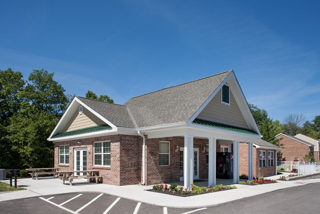 an exterior view of a brick building with a porch