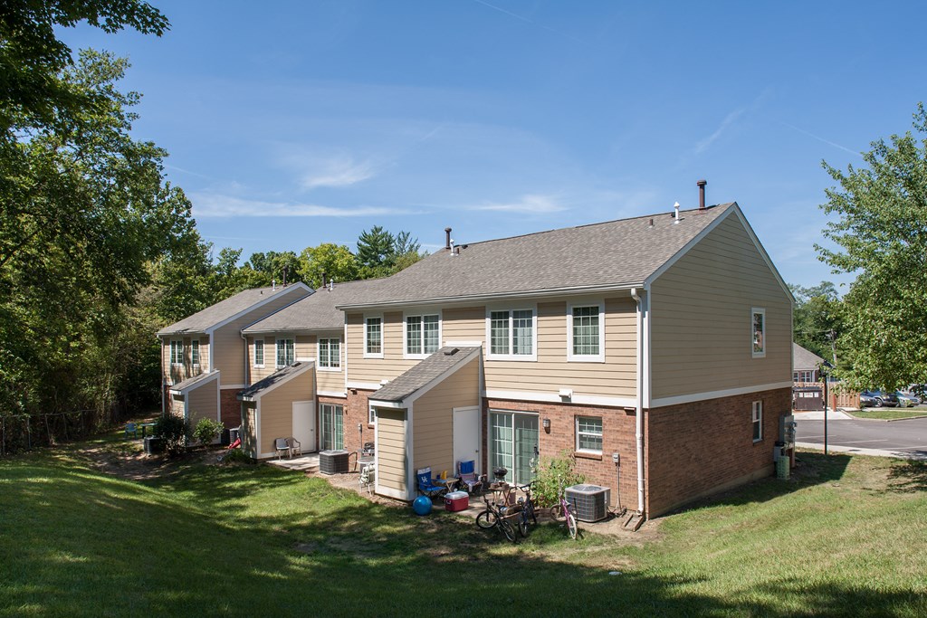 a view of a house with a lawn and trees