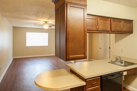 the view of a kitchen from the living room of an empty home