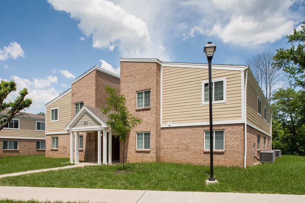 a brick building with a lamp post in front of it