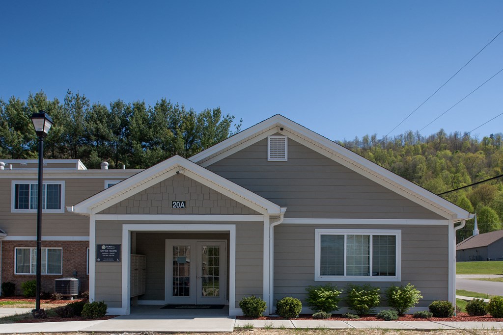 a gray house with a street light in front of it