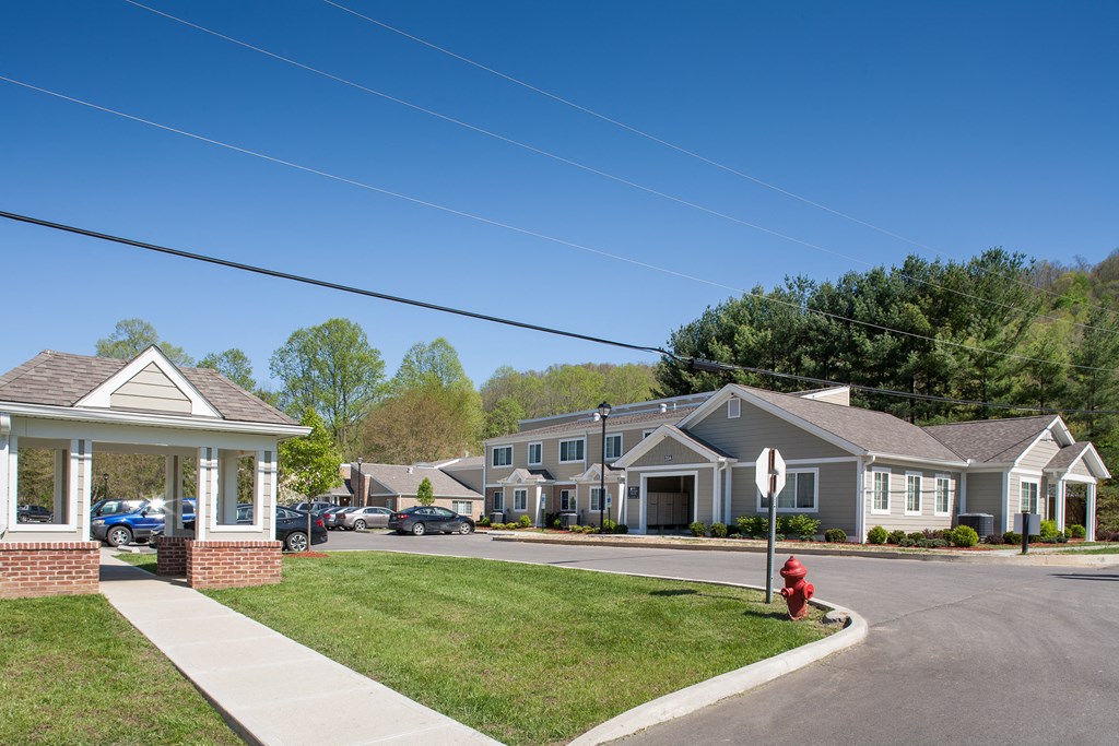 a row of houses on a street with a red fire hydrant