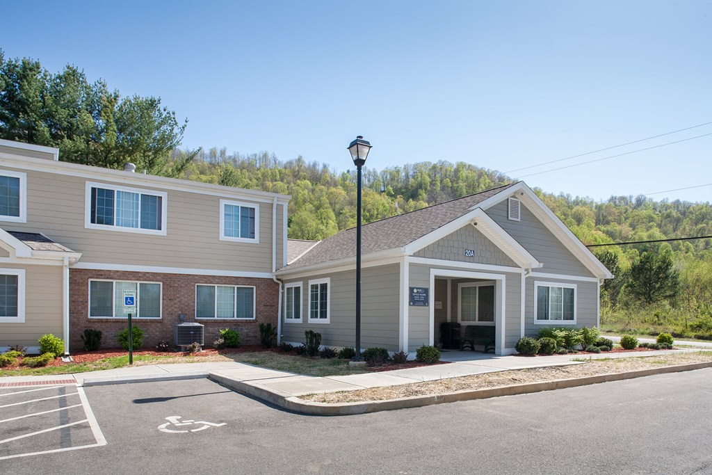 a house with a parking lot and a street light in front of it