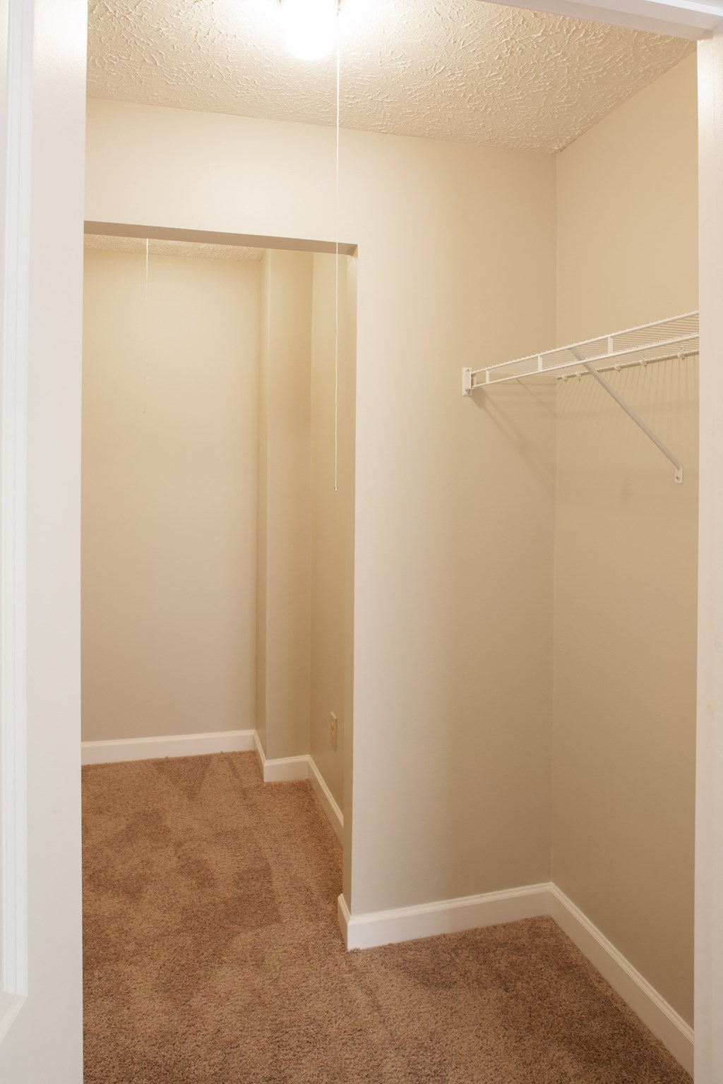 a bedroom with a closet and a hanging closet