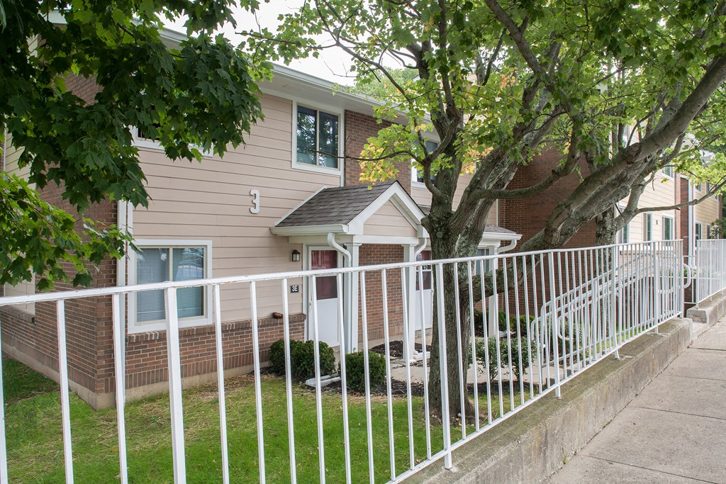 a house with a white fence in front of it