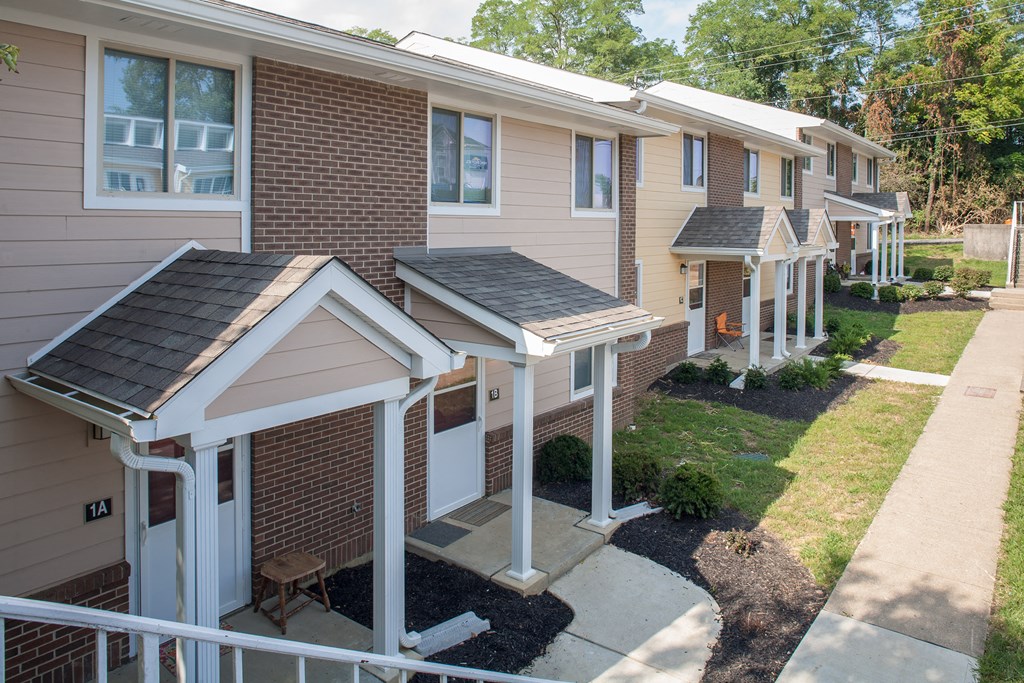 an aerial view of a row of houses with a sidewalk