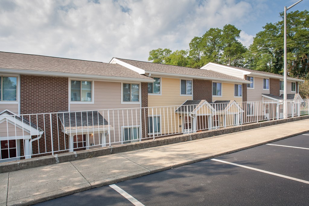 a row of town homes behind a white fence