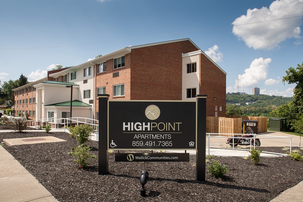 a high point apartments sign in front of a building