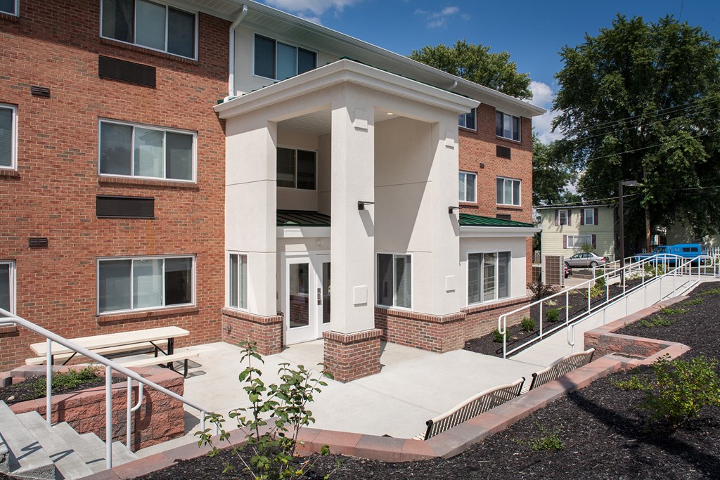 a large brick building with stairs in front of it