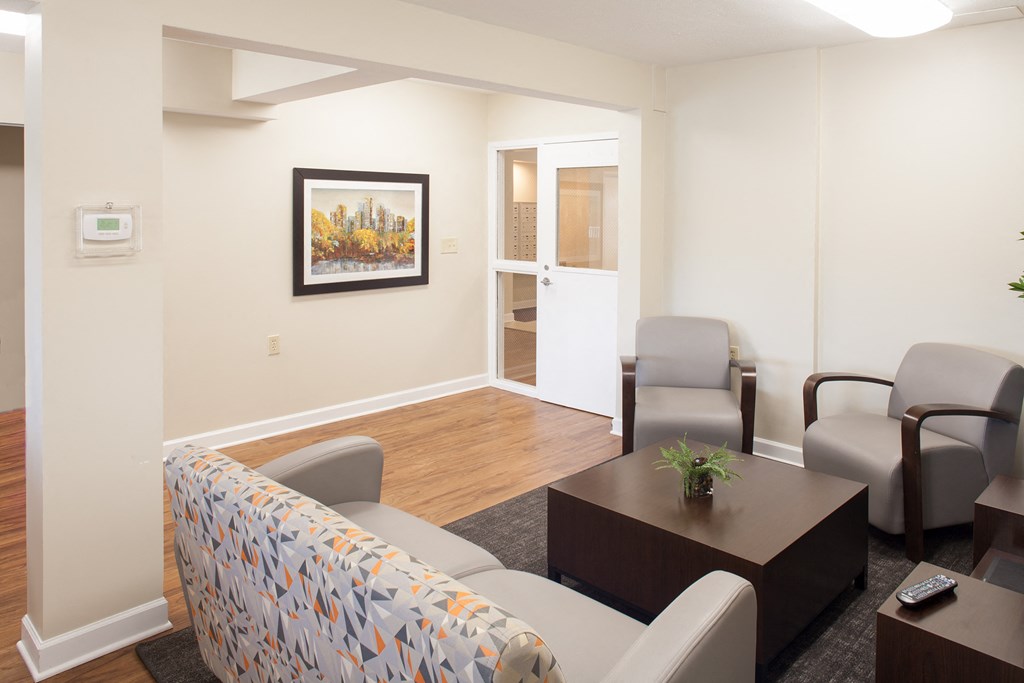 a living room with a couch and chairs and a table