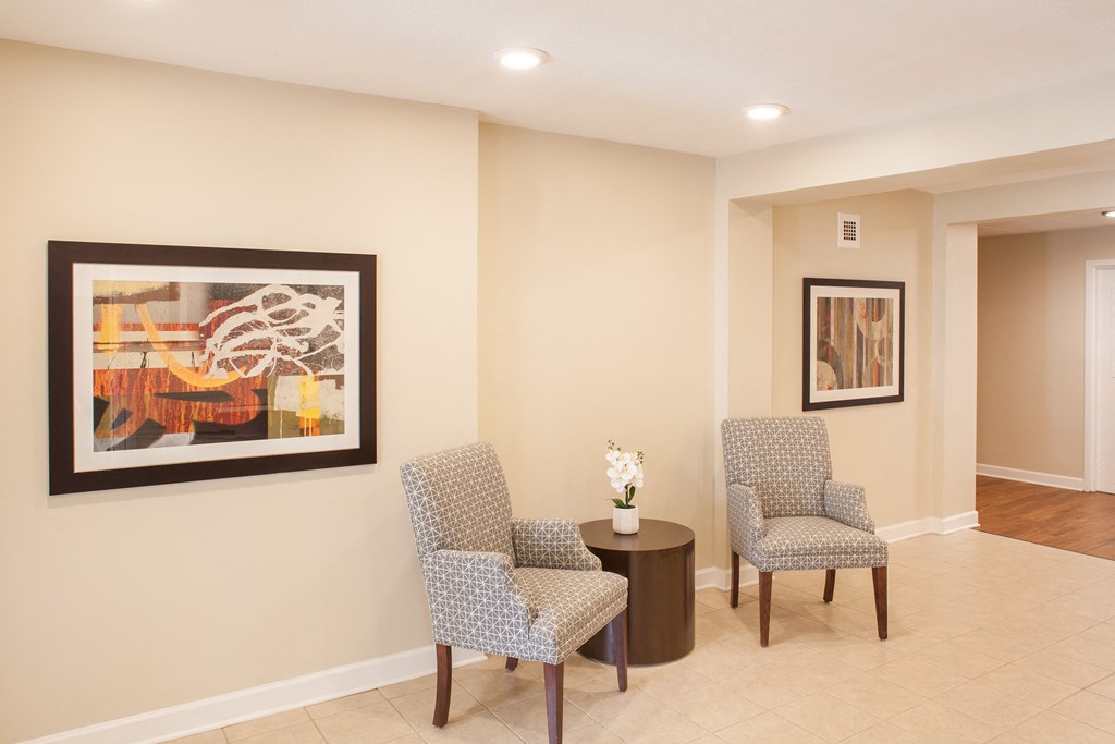 a living room with two chairs and a table