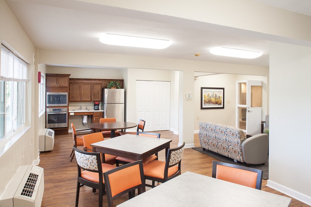 a living room and dining room with a table and chairs