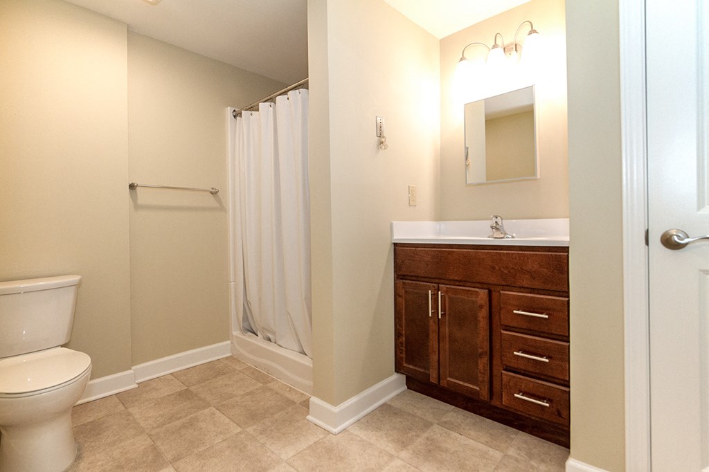 a bathroom with a toilet sink and shower