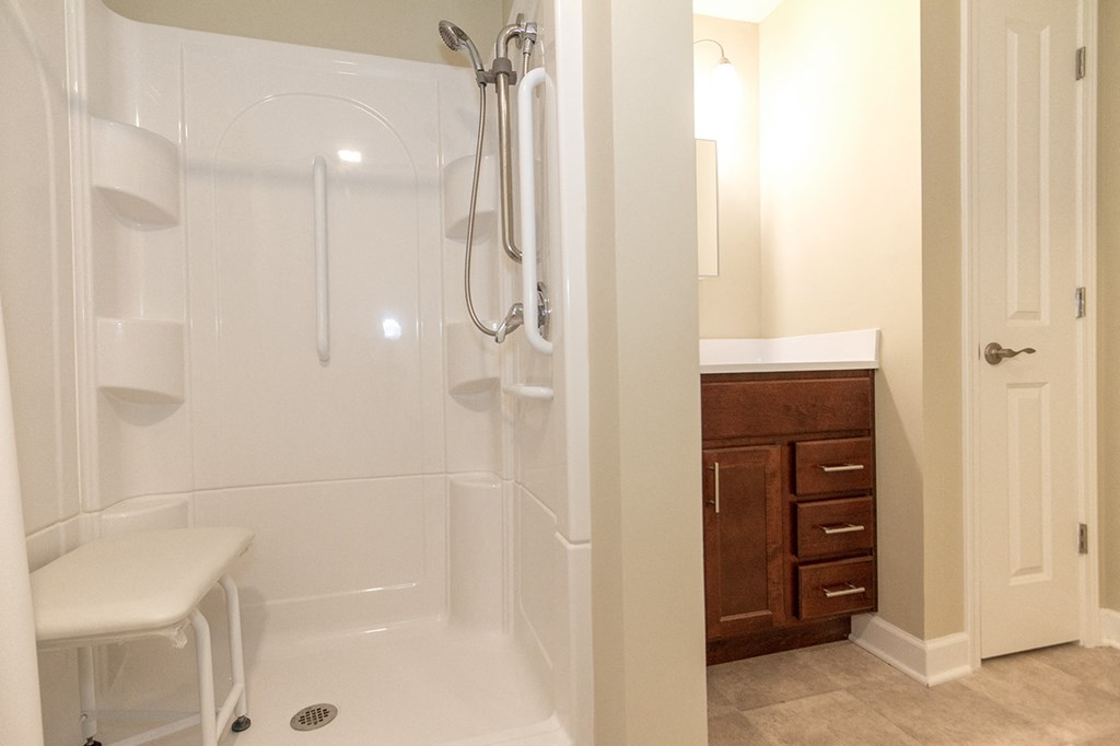 a bathroom with a shower and a sink and a toilet