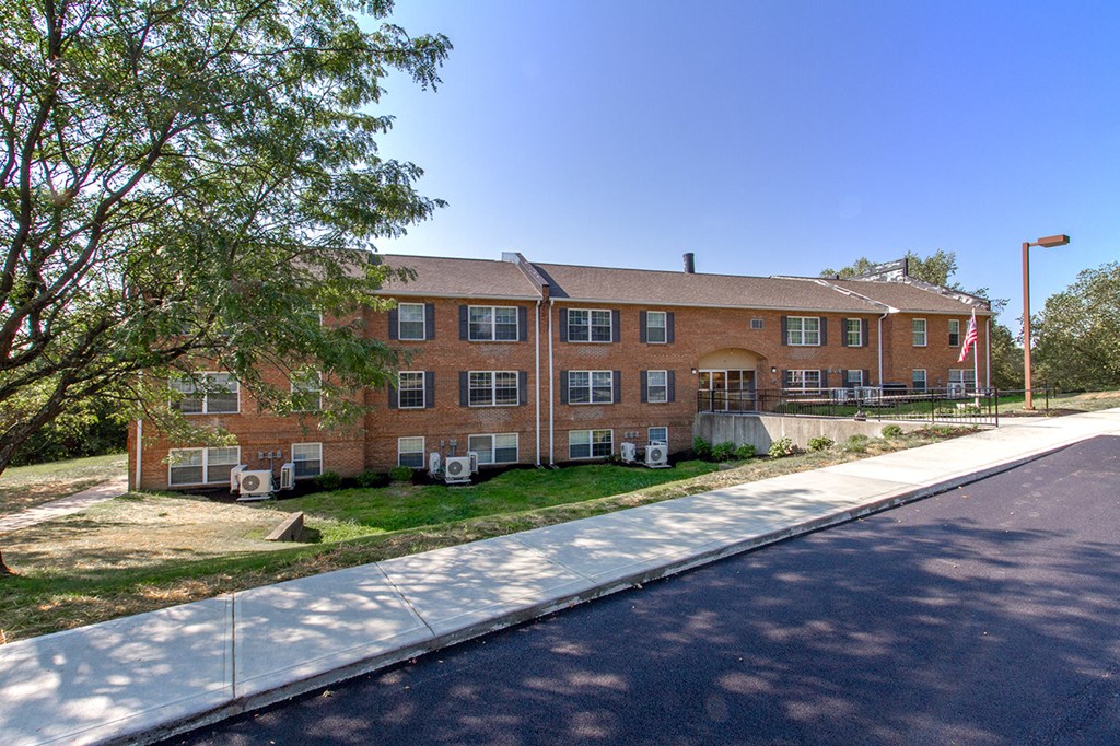 a large brick building with a street in front of it