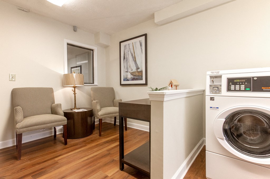 a living room with a washing machine and a dryer in it