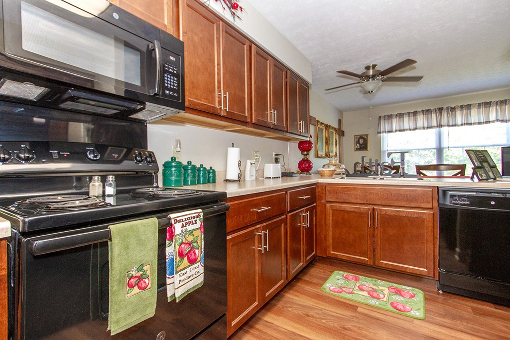 a kitchen with black appliances and wooden cabinets