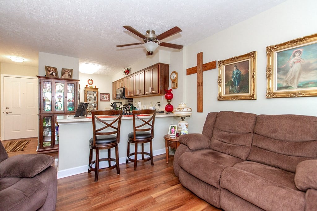 a living room and kitchen with a couch and a bar