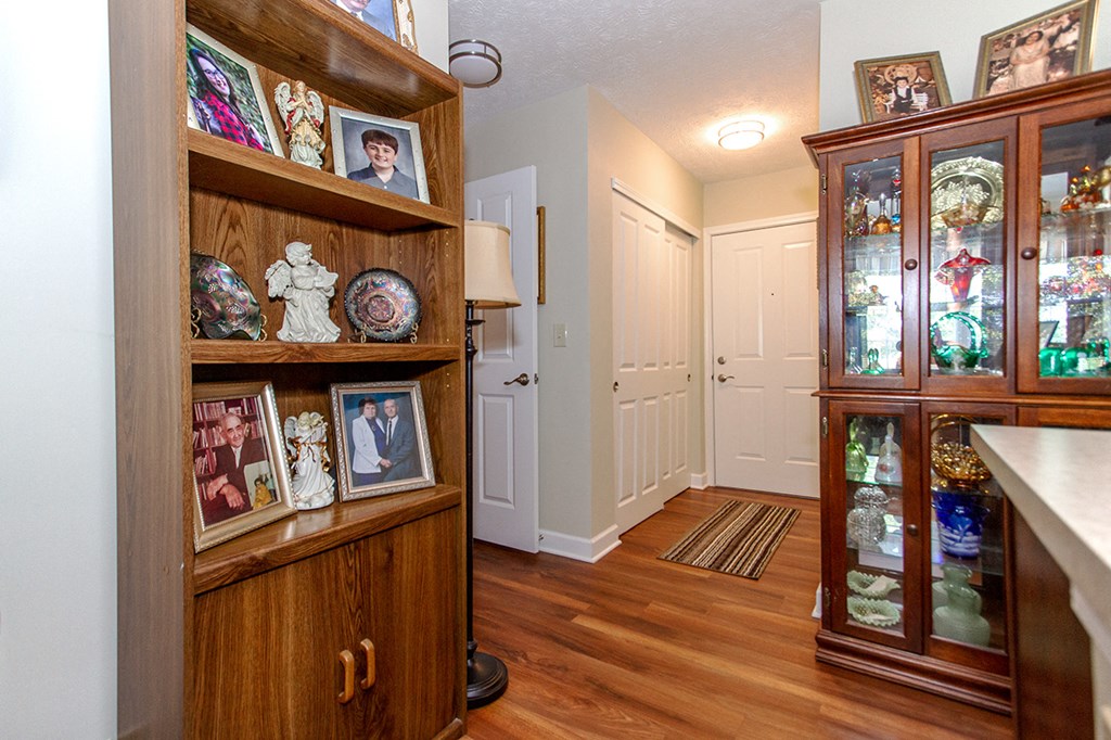 a room with a cabinet and a hallway with a door