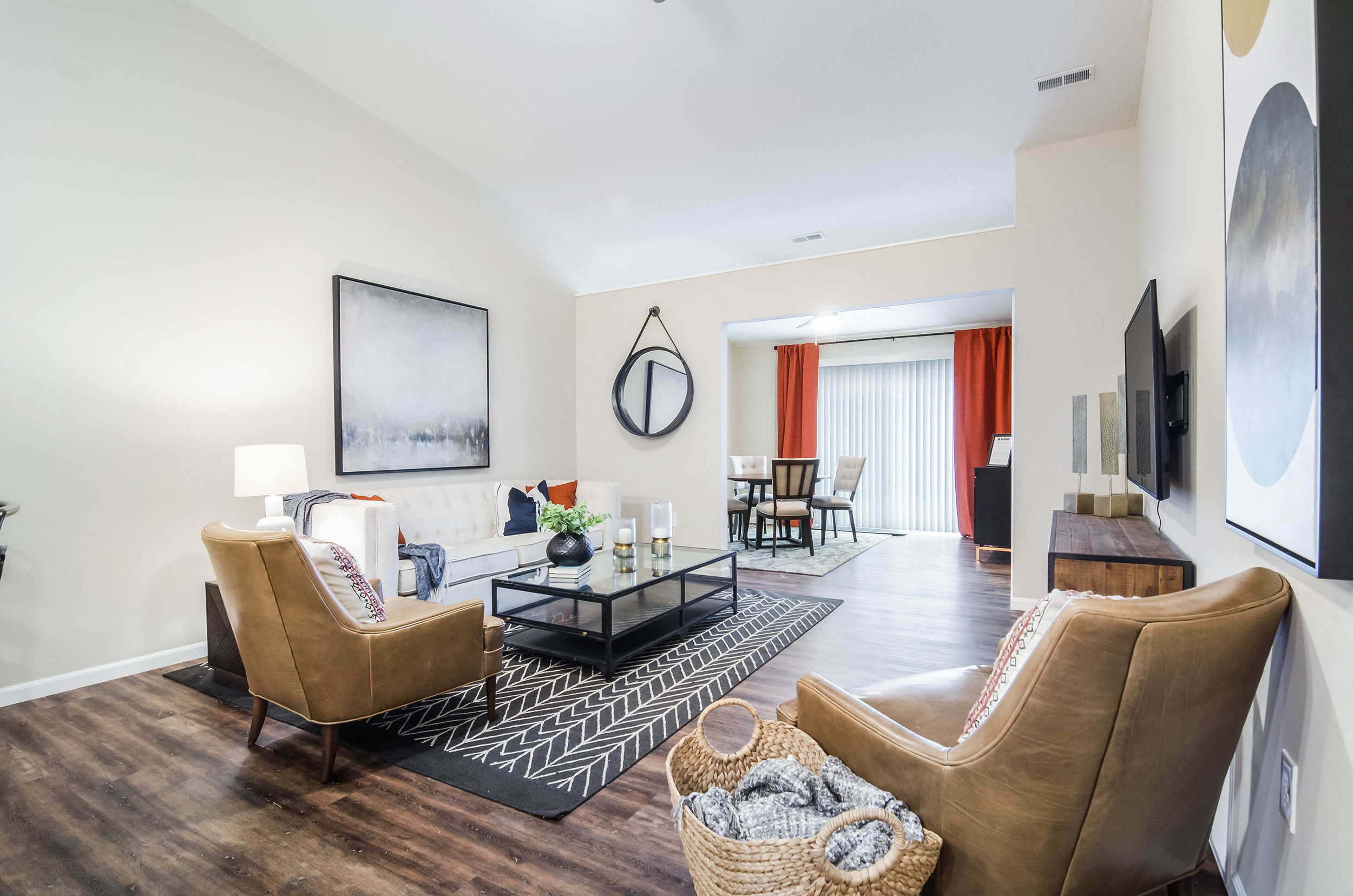 a living room with two chairs and a couch and a table