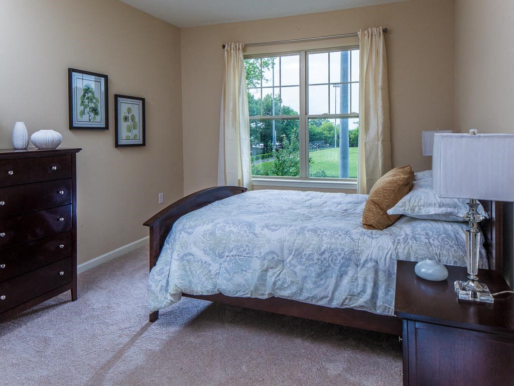 a bedroom with a bed and a window