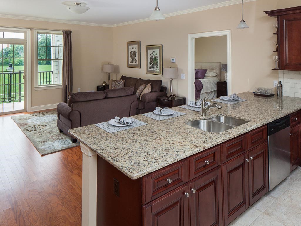 a kitchen and living room with a granite counter top