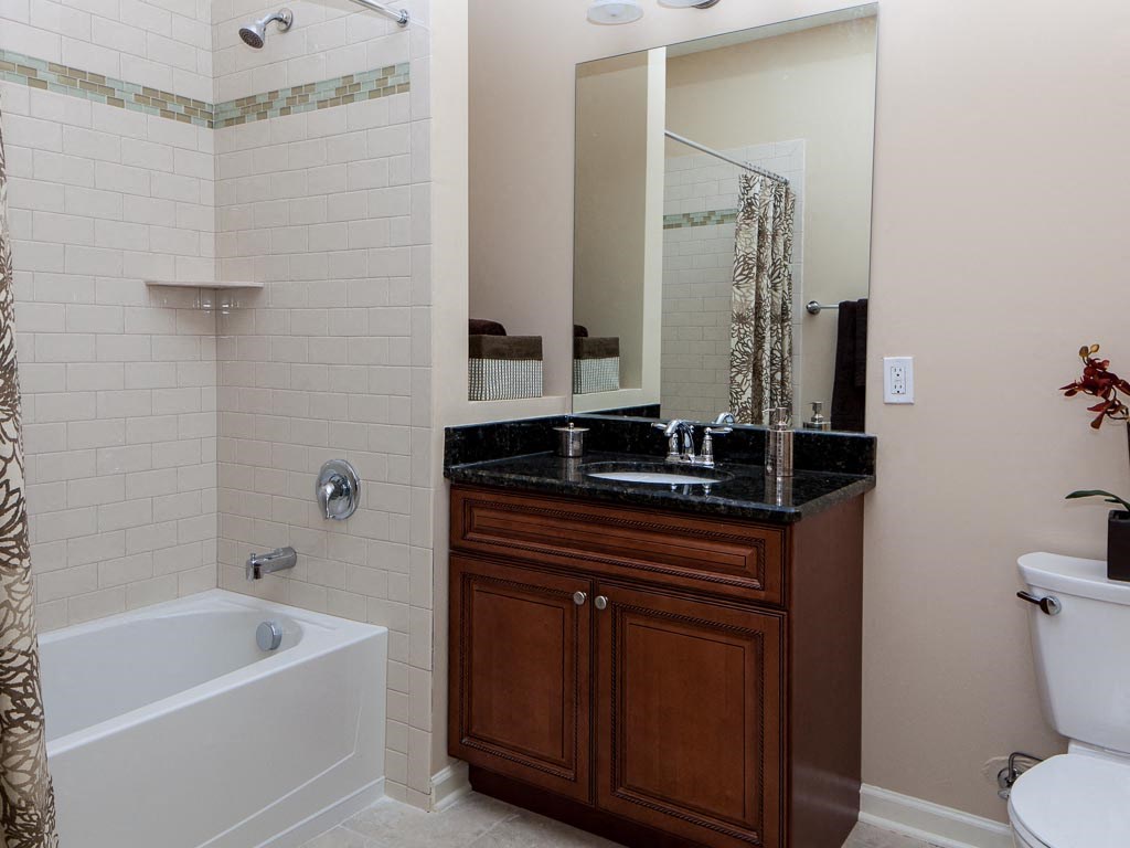 a bathroom with a sink and a tub and a mirror