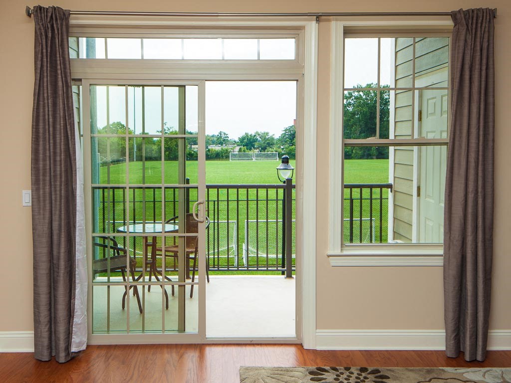 a room with a table and chairs on a balcony