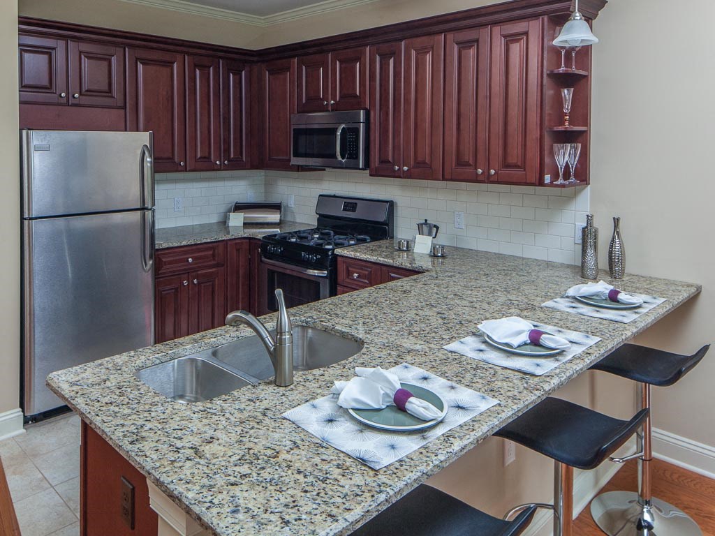 a kitchen with granite counter tops and stainless steel appliances