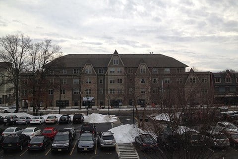 a parking lot full of cars in front of a large building