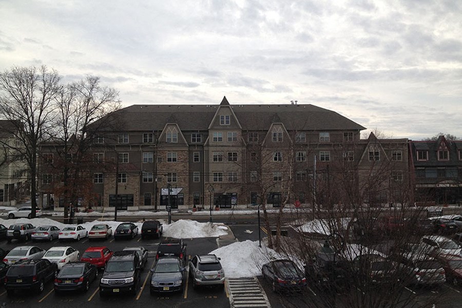 a parking lot full of cars in front of a large building