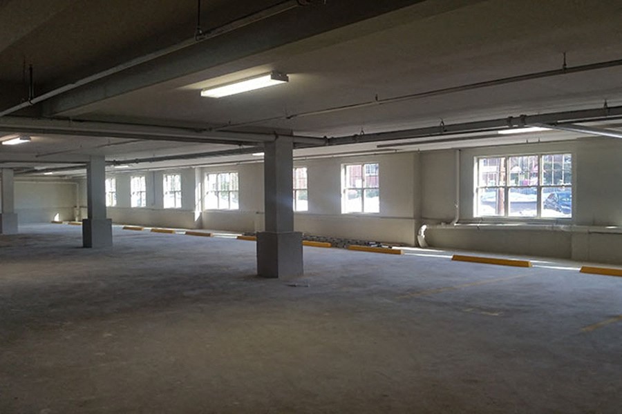 a large empty parking garage with windows in it