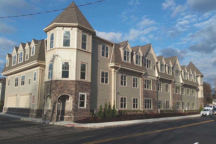 an apartment building on the corner of a street