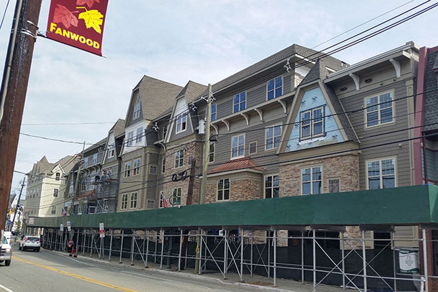 a building under construction on the side of a street