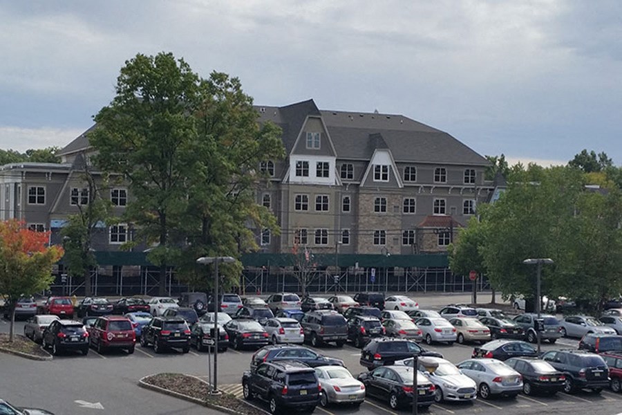 a parking lot full of cars in front of a building