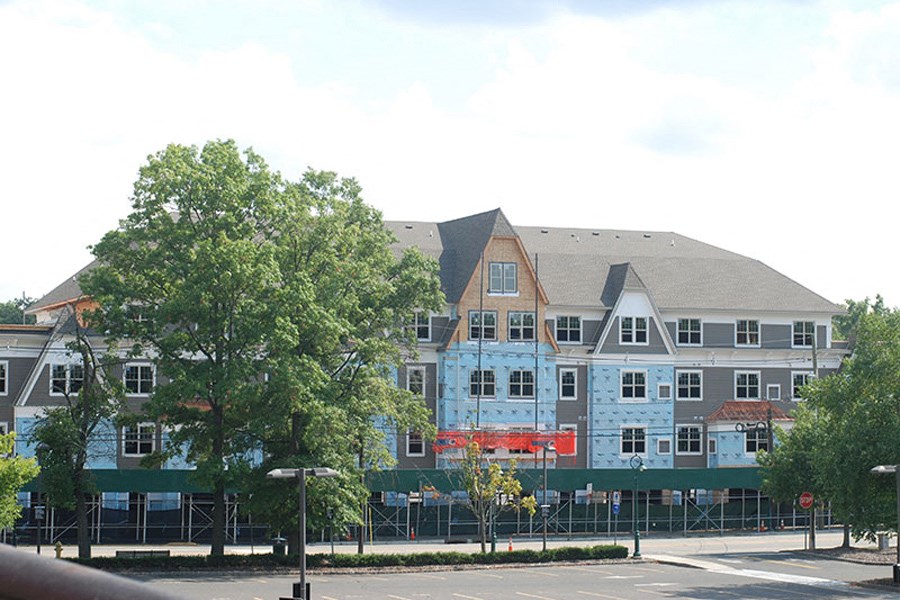 an apartment building with a construction fence in front of it