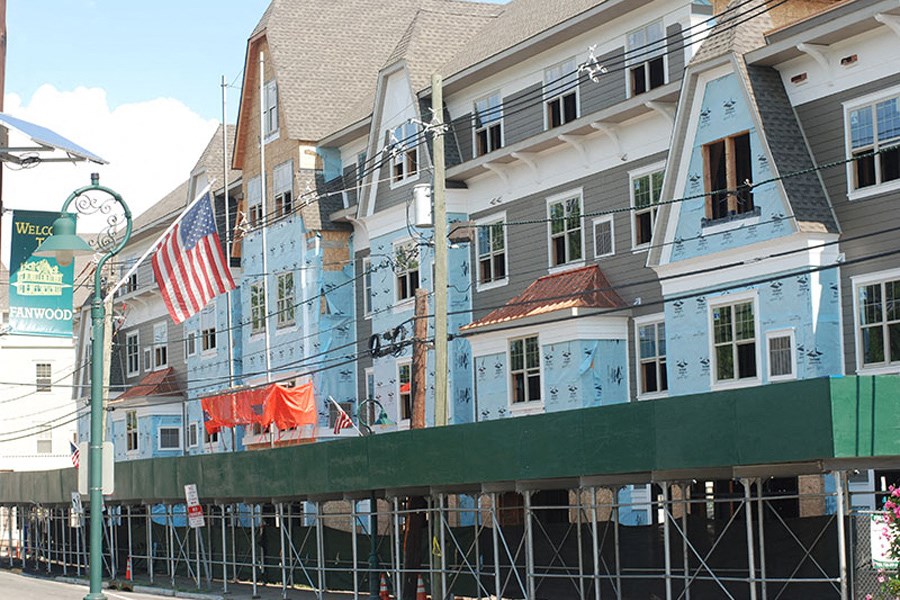 a building with scaffolding and an flag in front of it
