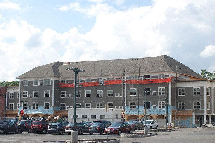a building under construction with cars parked in front of it