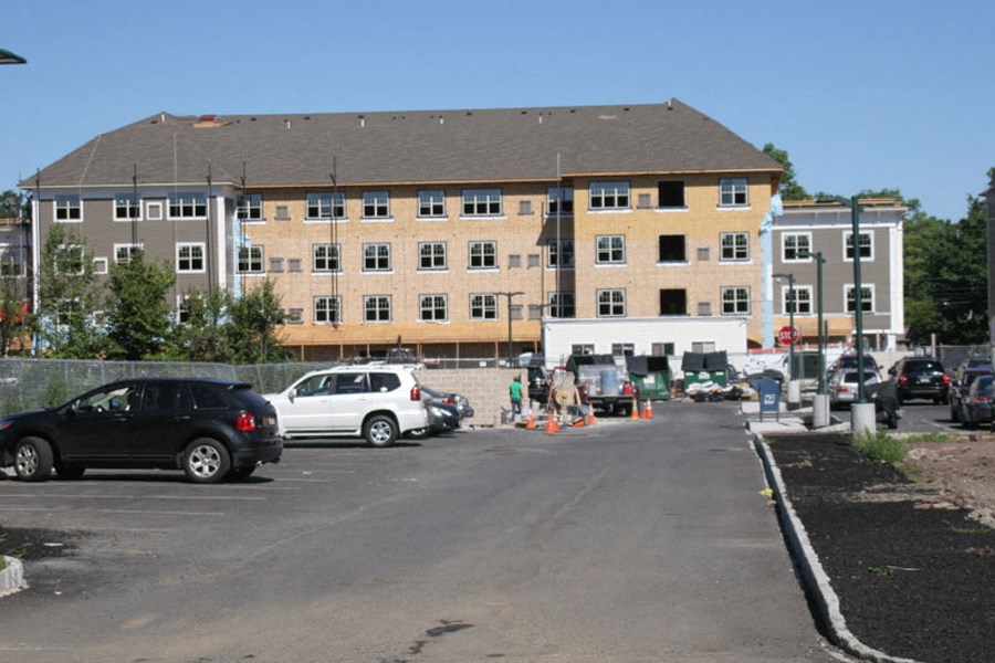 a parking lot with cars in front of a building
