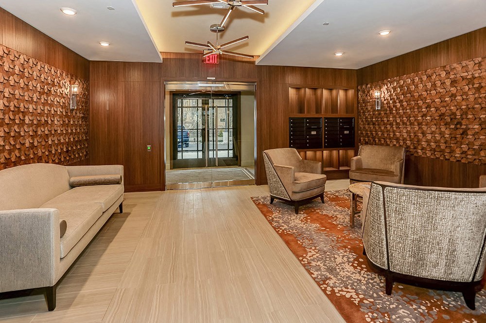 a lobby with couches and chairs and a door
