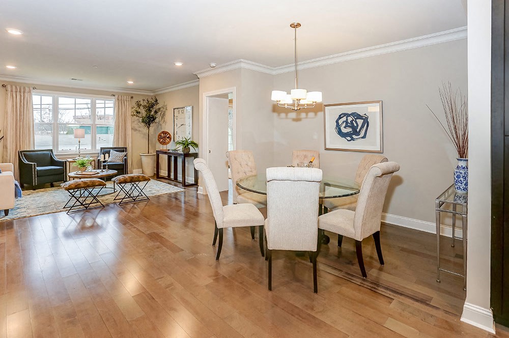 a dining room and living room with a table and chairs