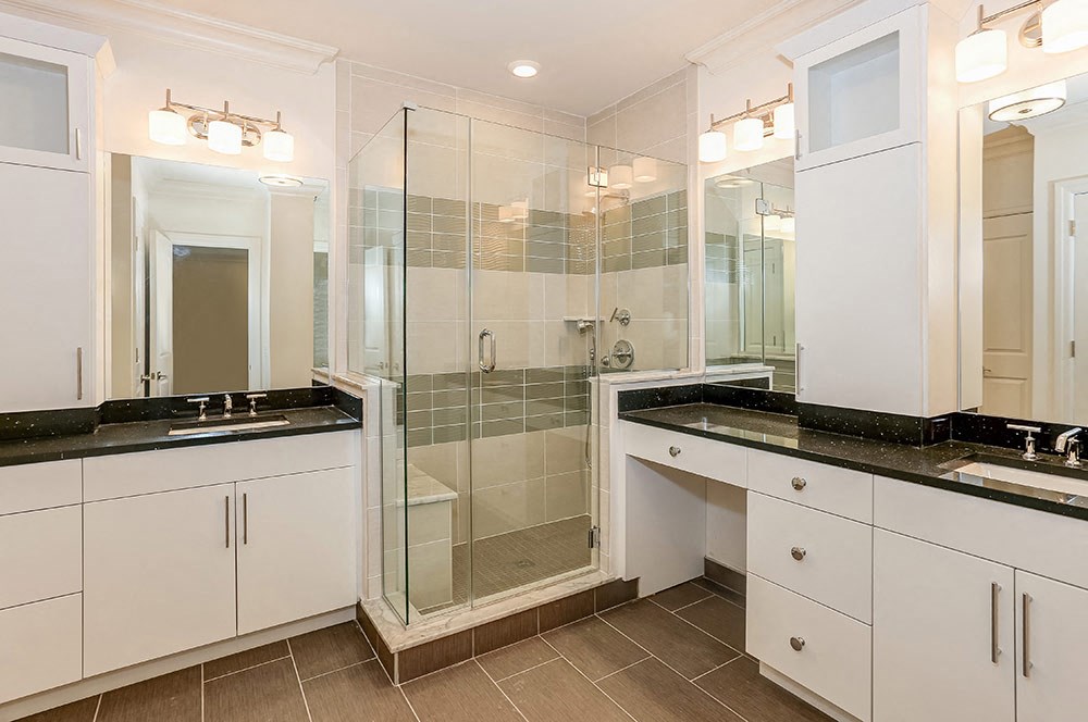 a bathroom with two sinks and a shower