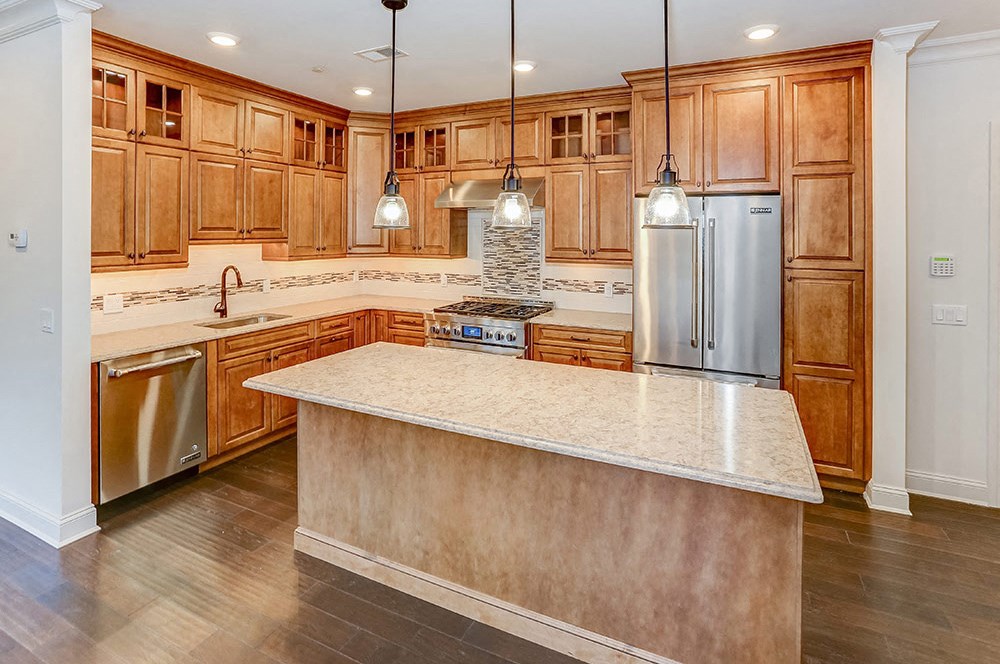 a large kitchen with wooden cabinets and a counter top